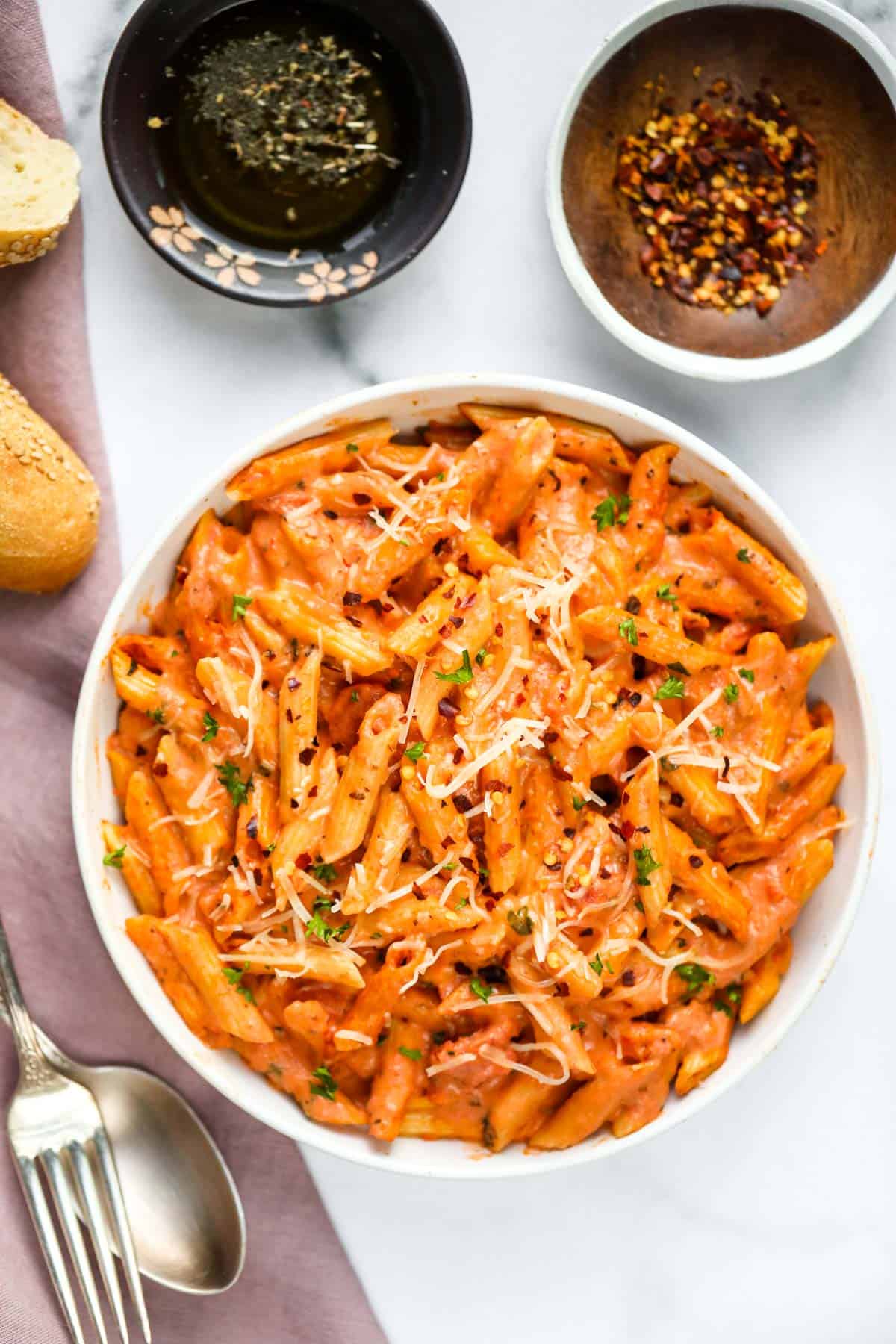 pasta with tomato cream sauce served in a white bowl