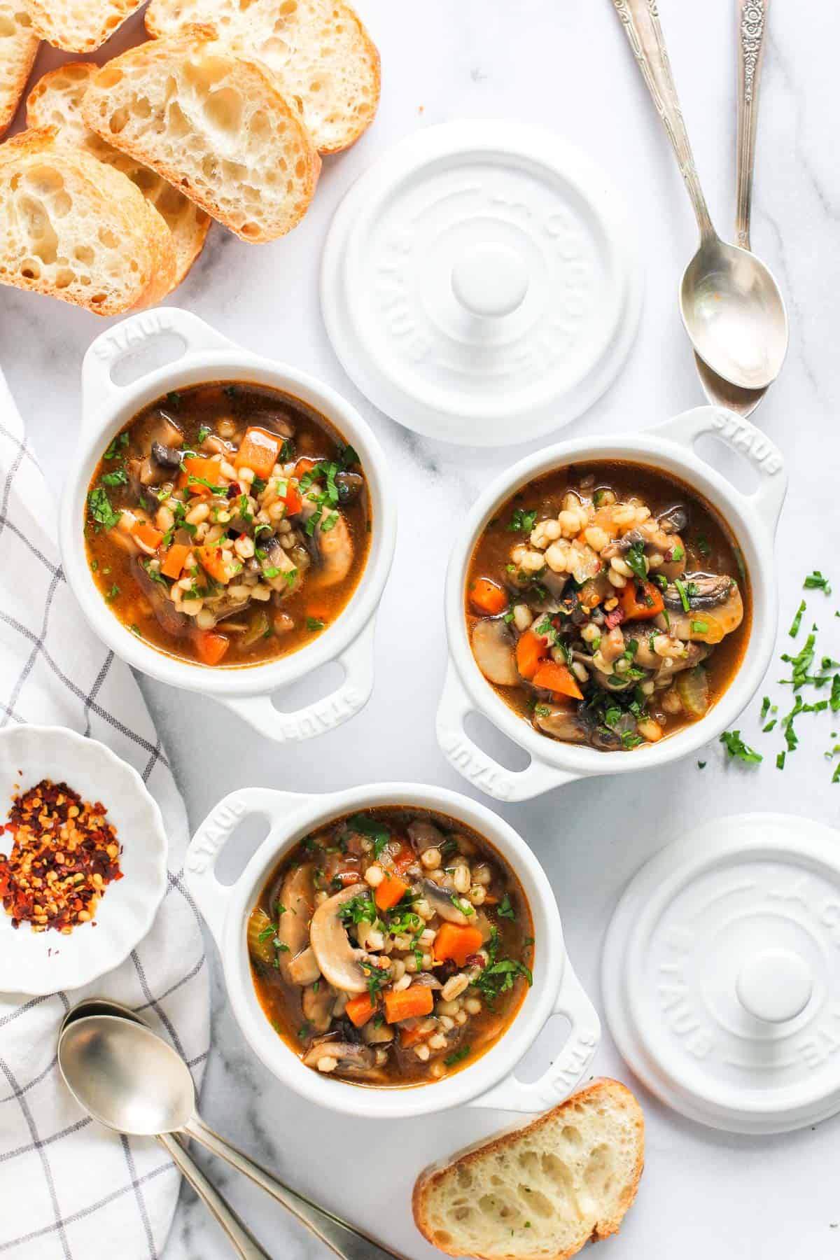 mushroom barley soup served in 3 white bowls 