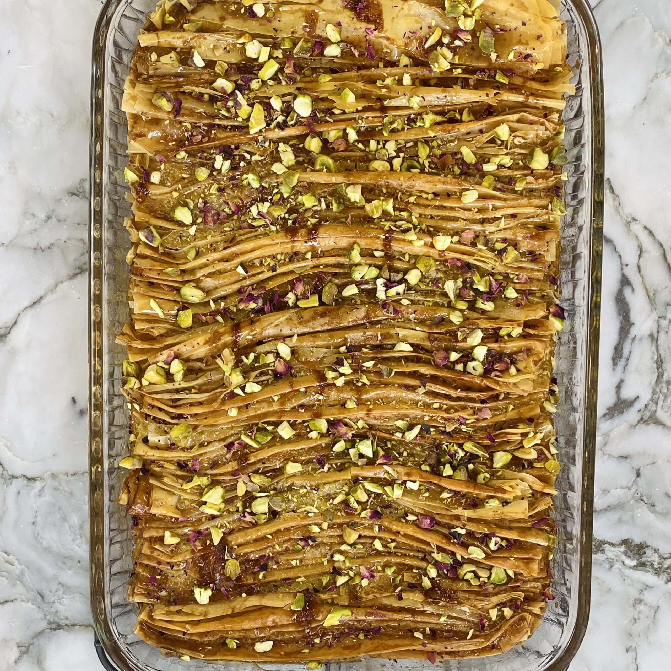 sugar syrup, pistachios and rose petals added to the phyllo  crinkle cake.