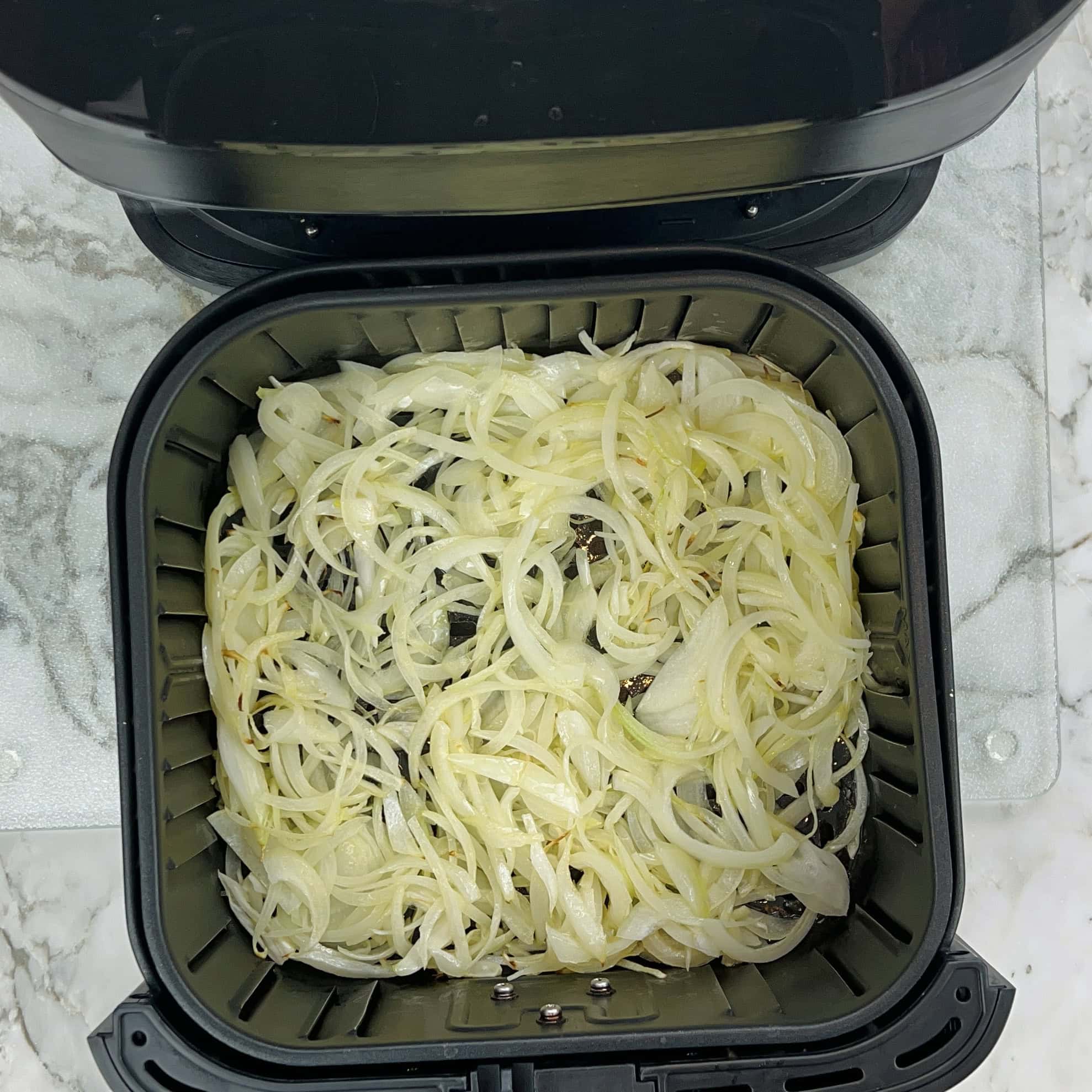 sliced onions after cooking for 5 mins in the air fryer 