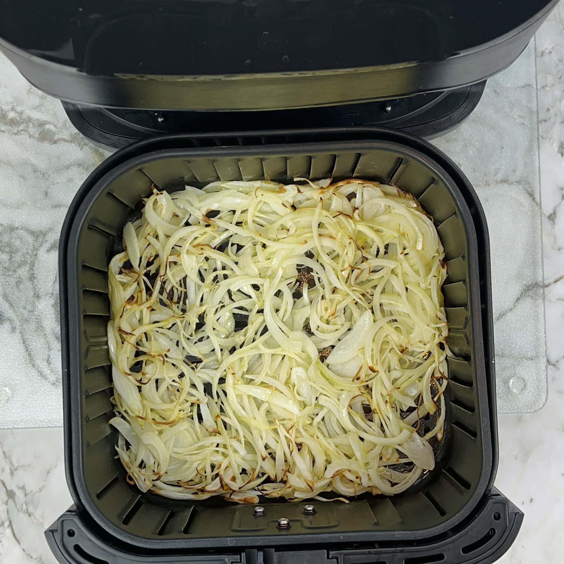 sliced onions after cooking for 10 mins in the air fryer 