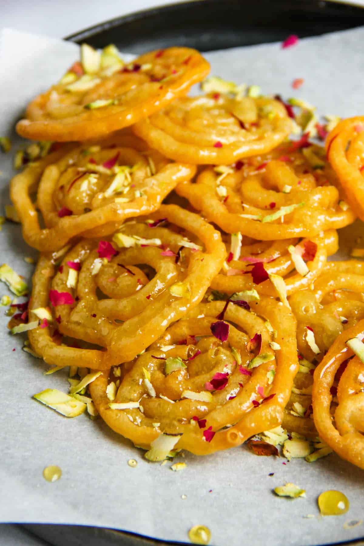 close up photo of Jalebis garnished with pistachios 