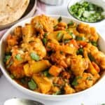potato and cauliflower stir fry served with roti and raita