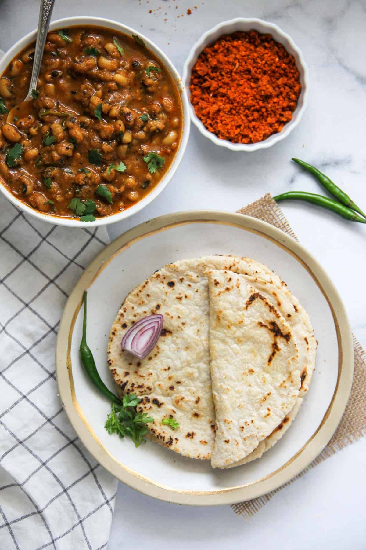 Jowar Roti served with black eyed peas curry and garlic chutney