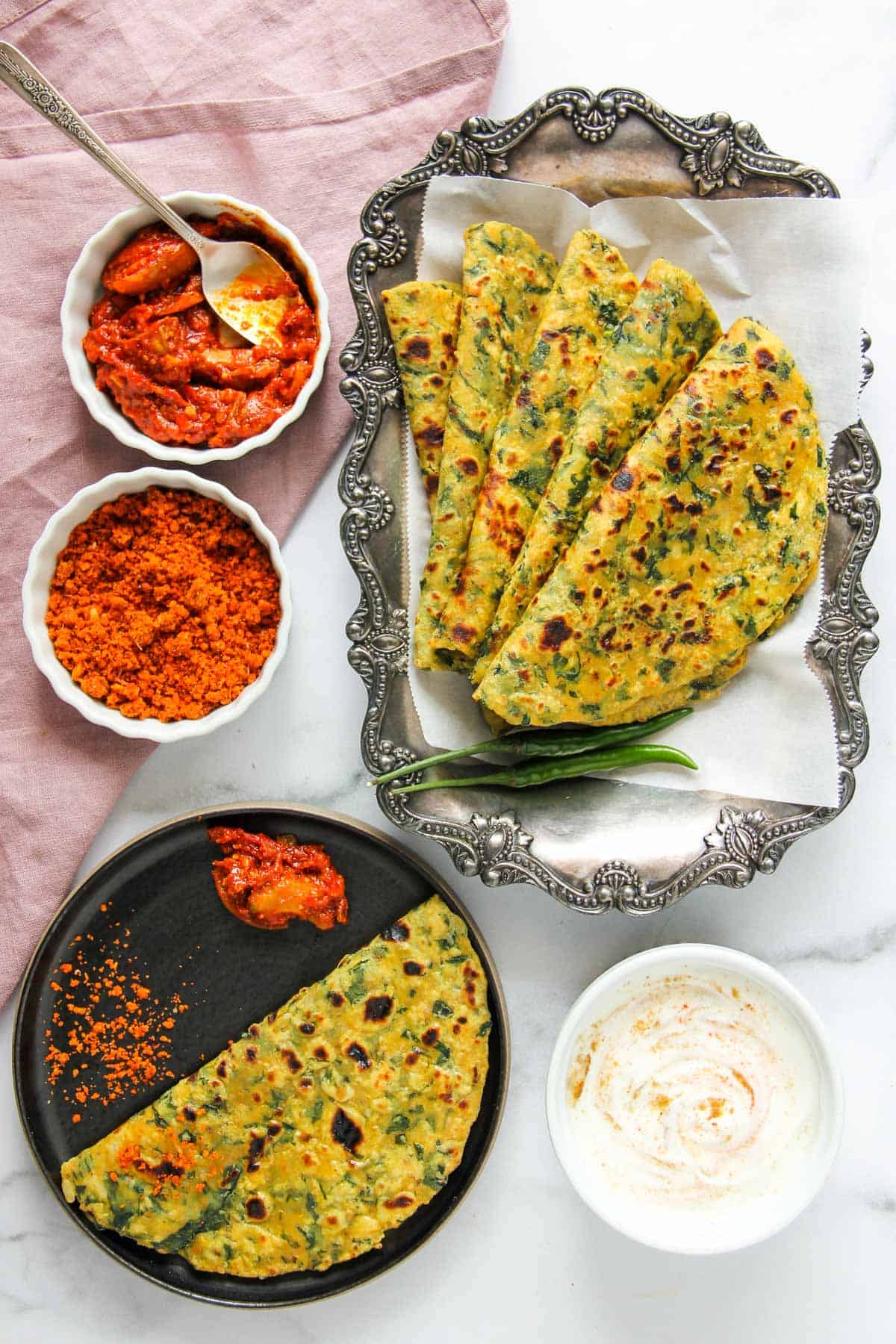 kale and potato parathas served with pickles, chutney and yogurt 