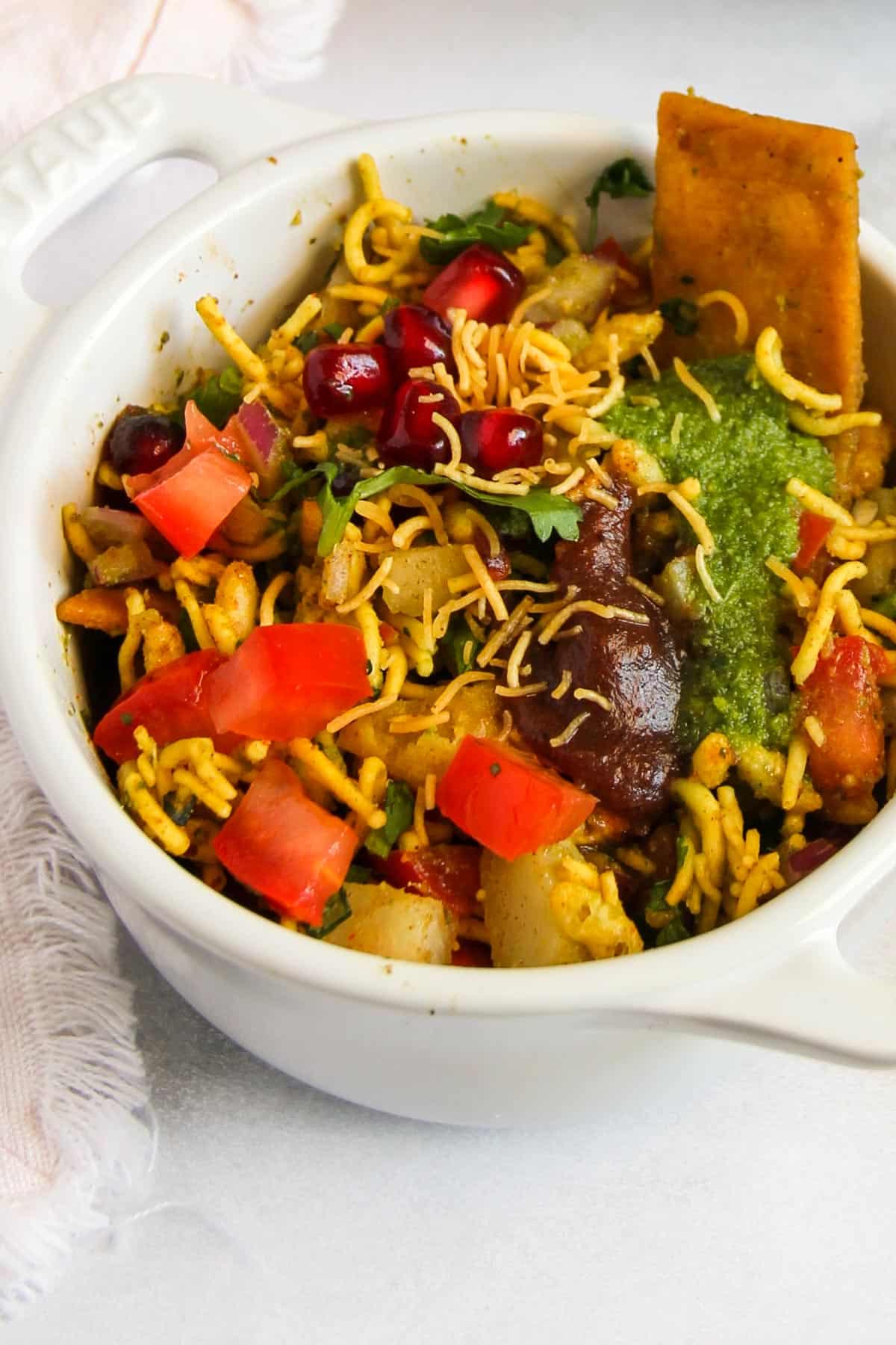 Bhel puri served in a white bowl. 