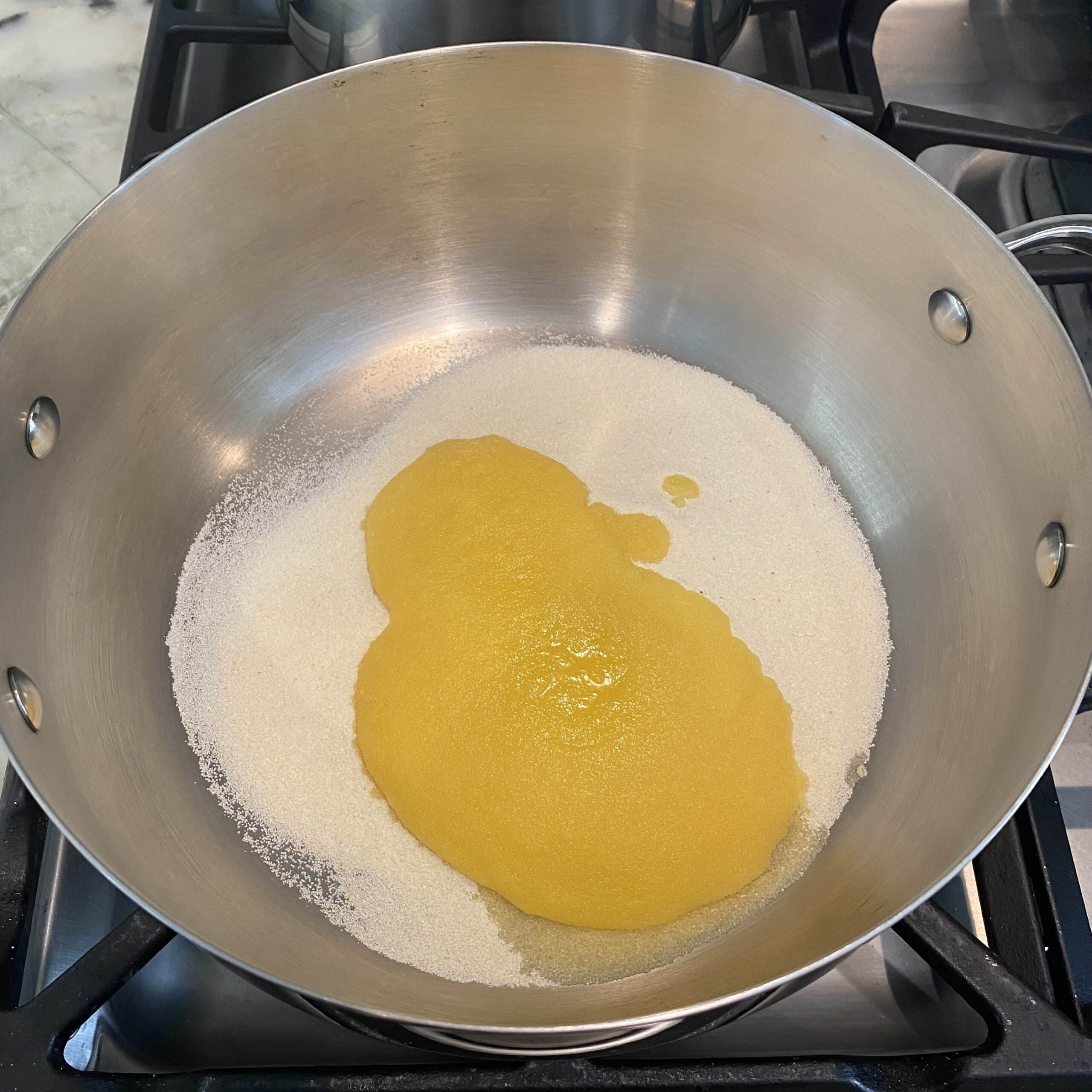 sooji and ghee added to a stainless steel pot. 