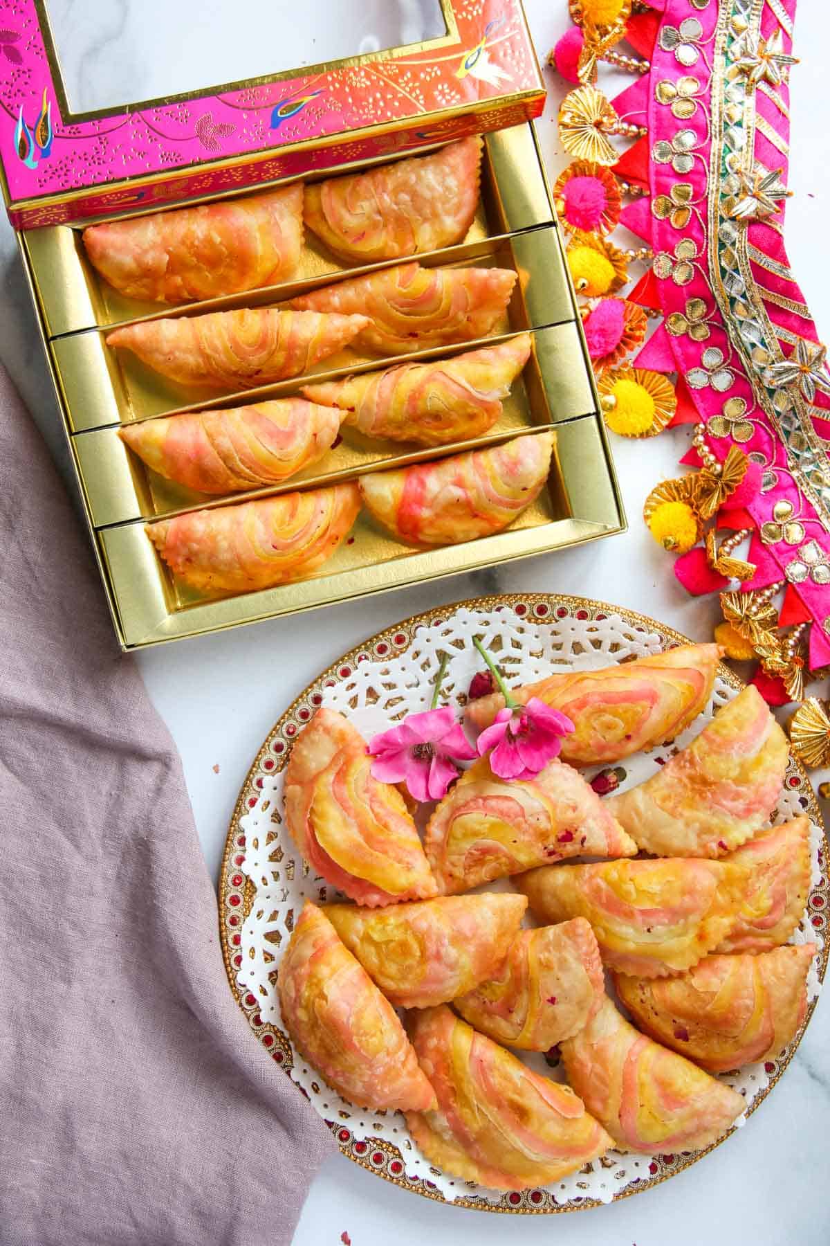 Rose Karanji in a plate and in a mithai box