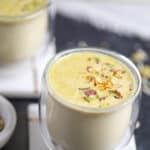Masala milk garnished with pistachios and saffron