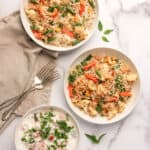 veg pulao in 2 white serving bowls with raita on the side