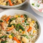 Veg Pulao in a white bowl with raita