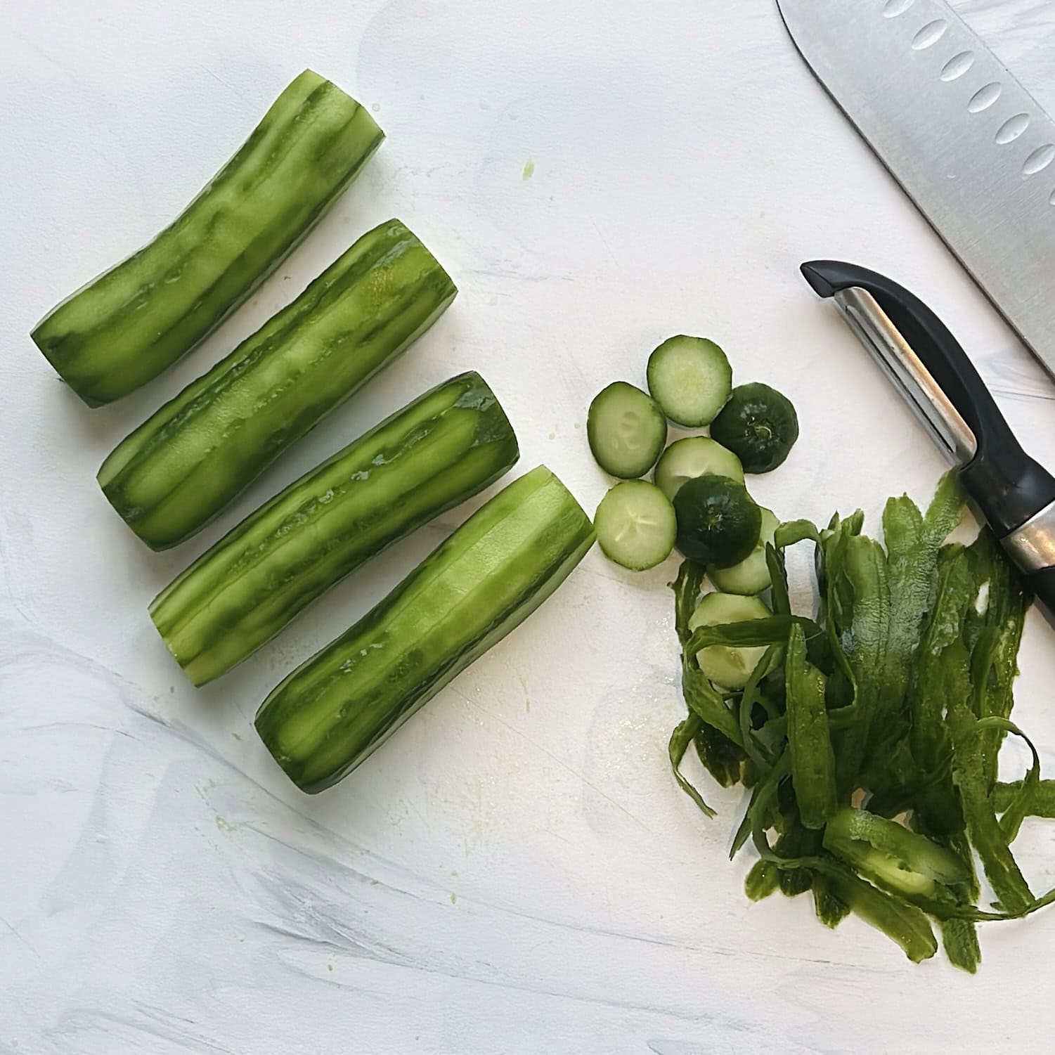 peeled cucumbers on cutting board,