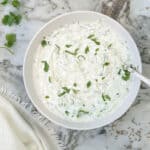mint cucumber raita in a white bowl