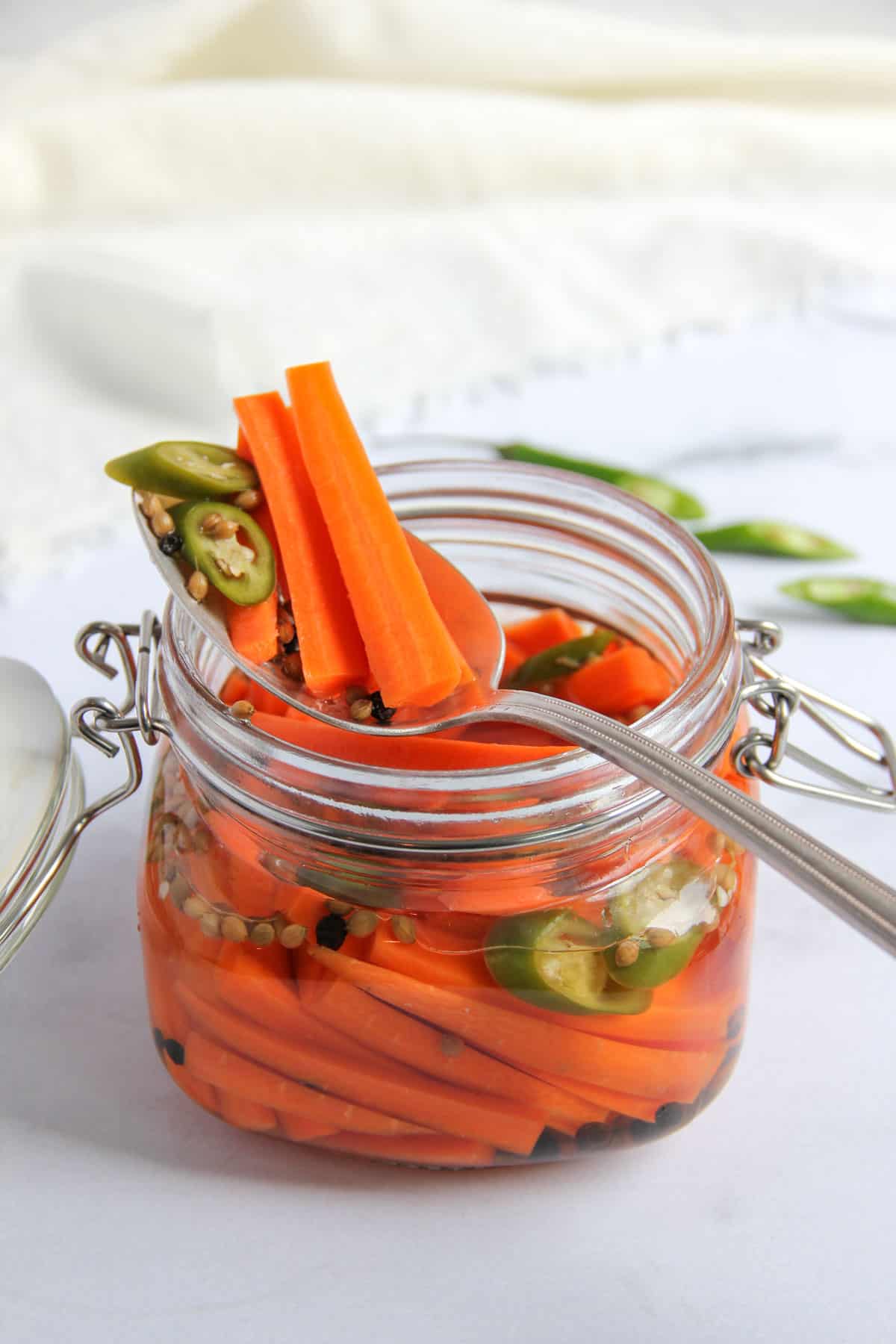 pickled carrots and chilies in a glass jar 