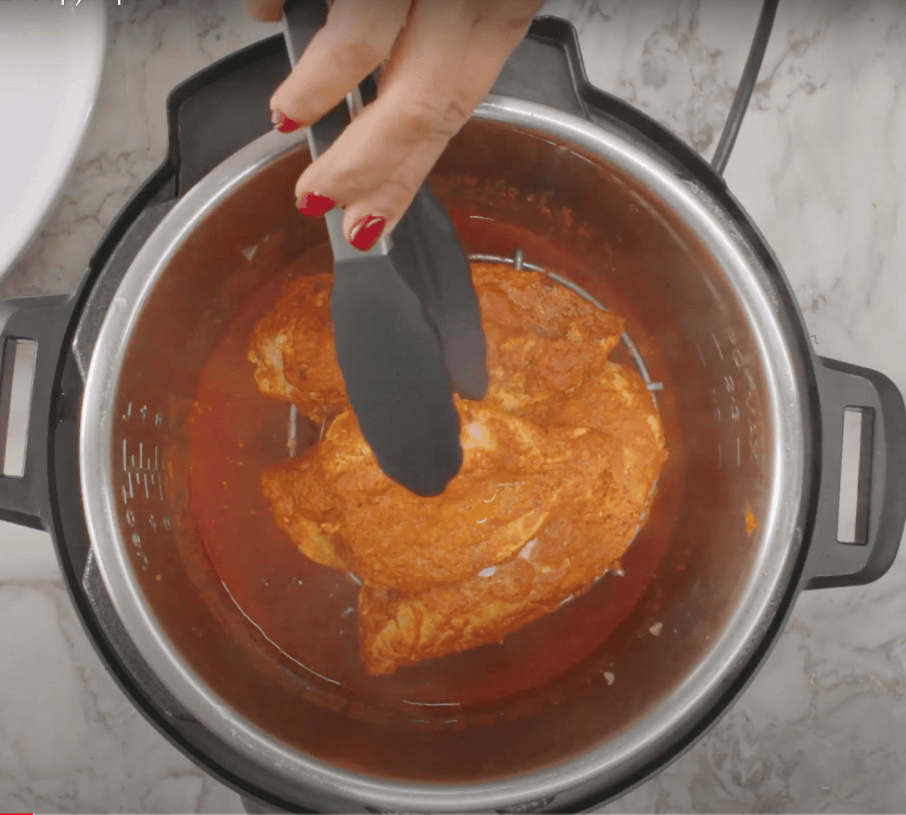 taking out cooking chicken from the instant pot