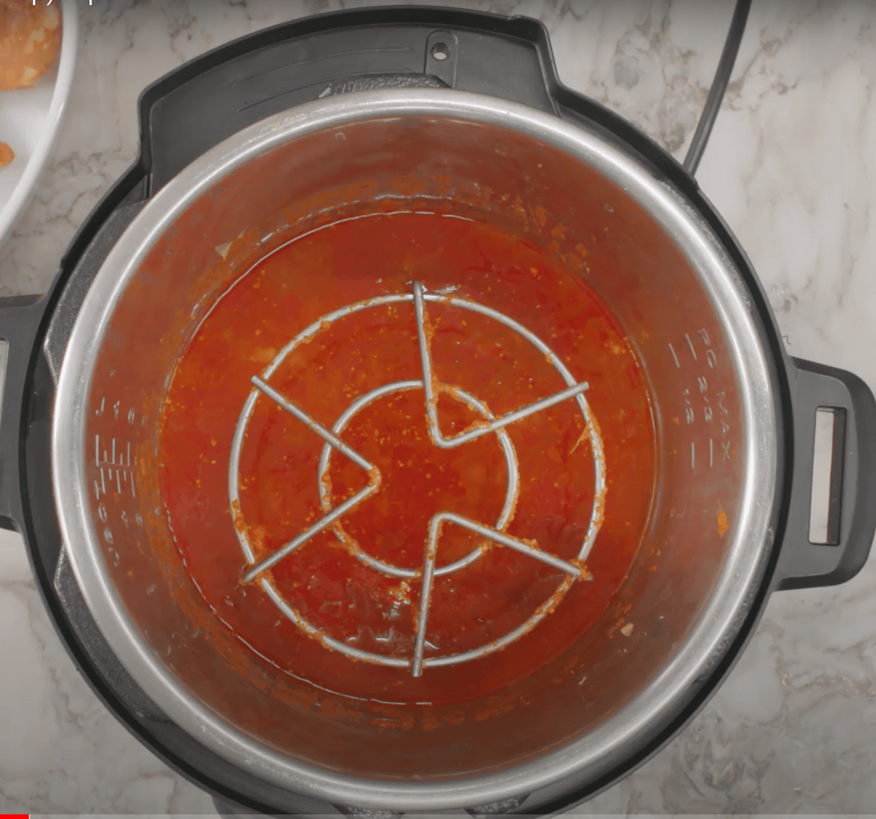 trivet and cooked sauce in the Instant Pot