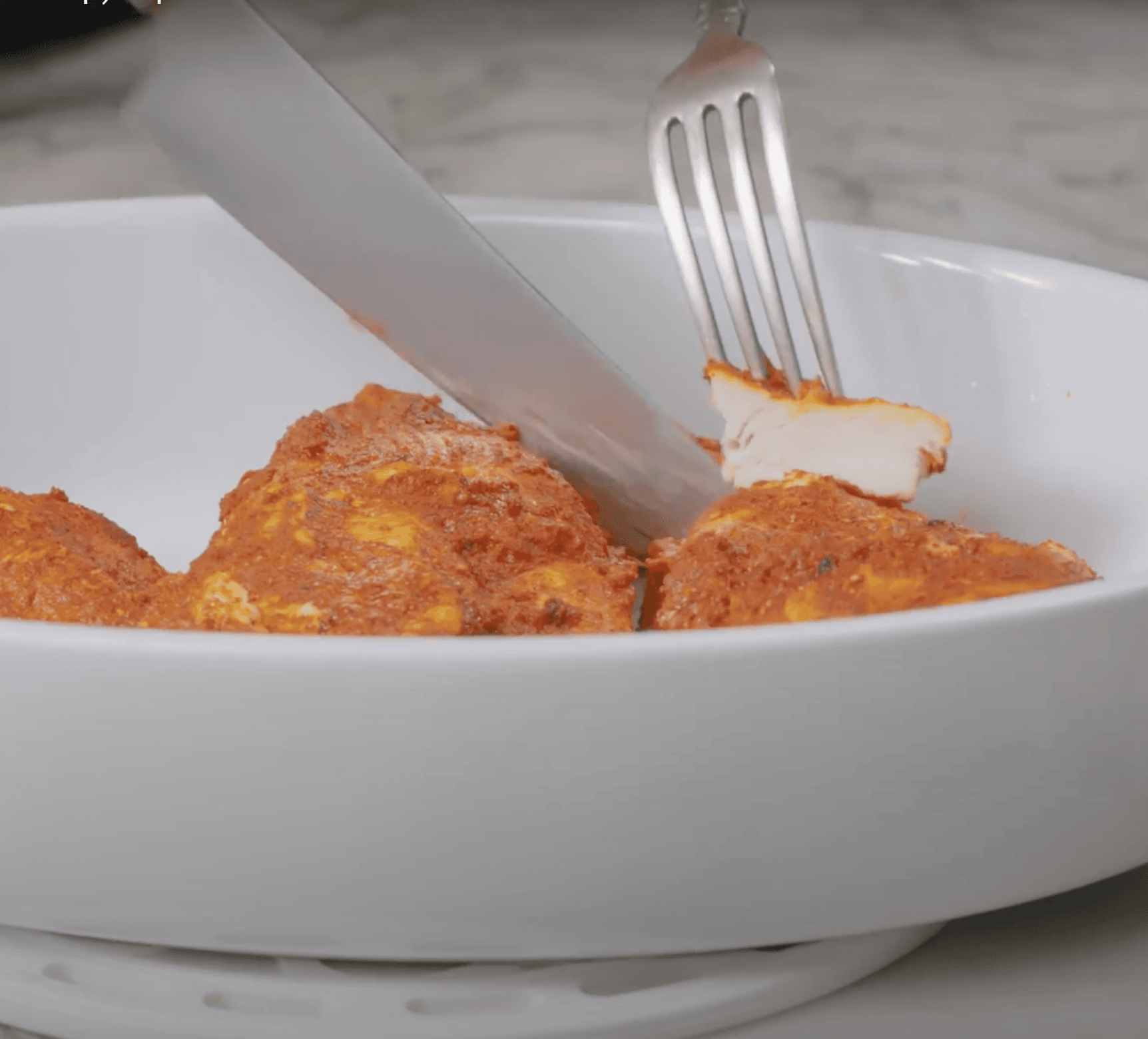 cutting cooked chicken into bite sized pieces