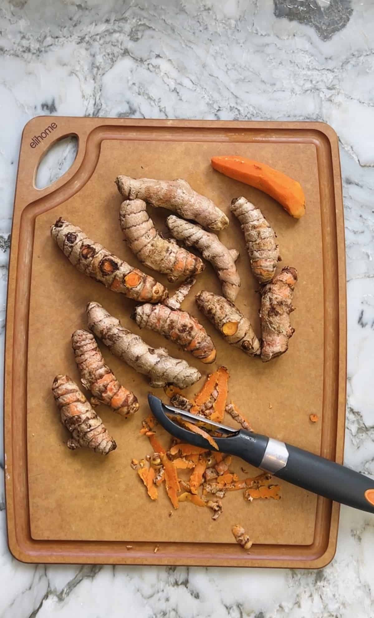 raw fresh turmeric on a cutting board 