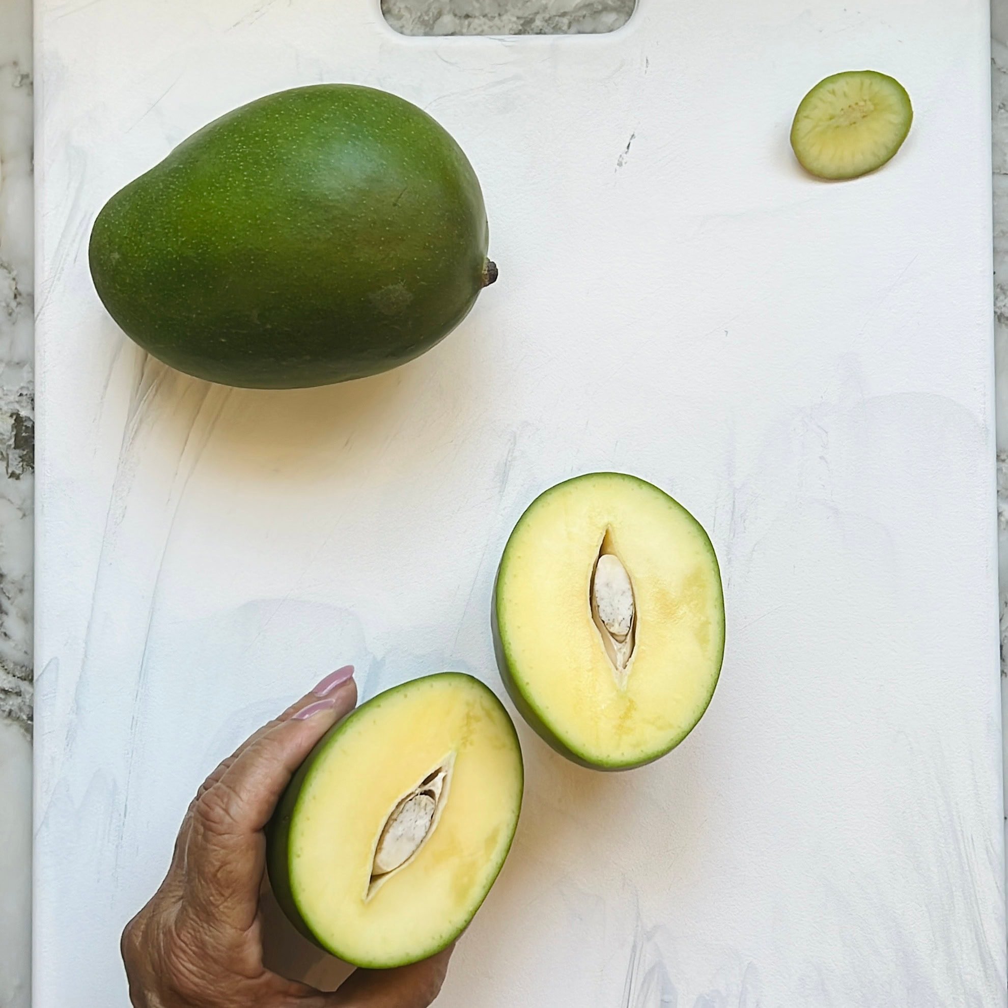 raw mango cut in half
