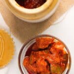 mango pickle in a glass bowl and ceramic jar