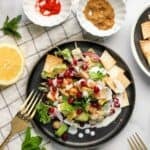 avocado chickpea chaat in a black plate