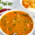 Sambhar served in a white bowl