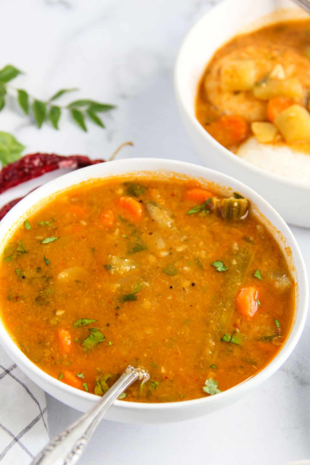 Sambhar served in a white bowl