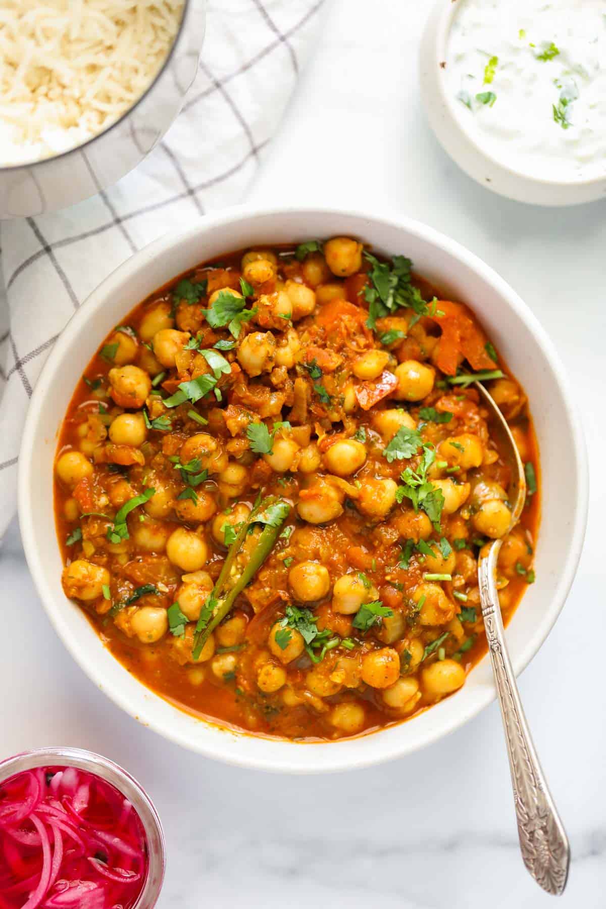 chana masala in a white bowl 