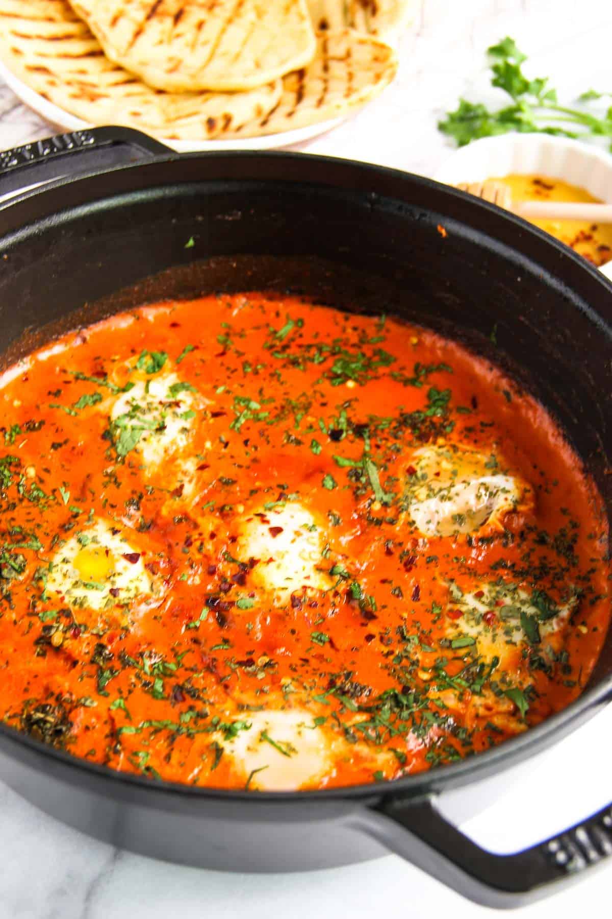 makhani shakshuka garnished with cilantro in a pan 