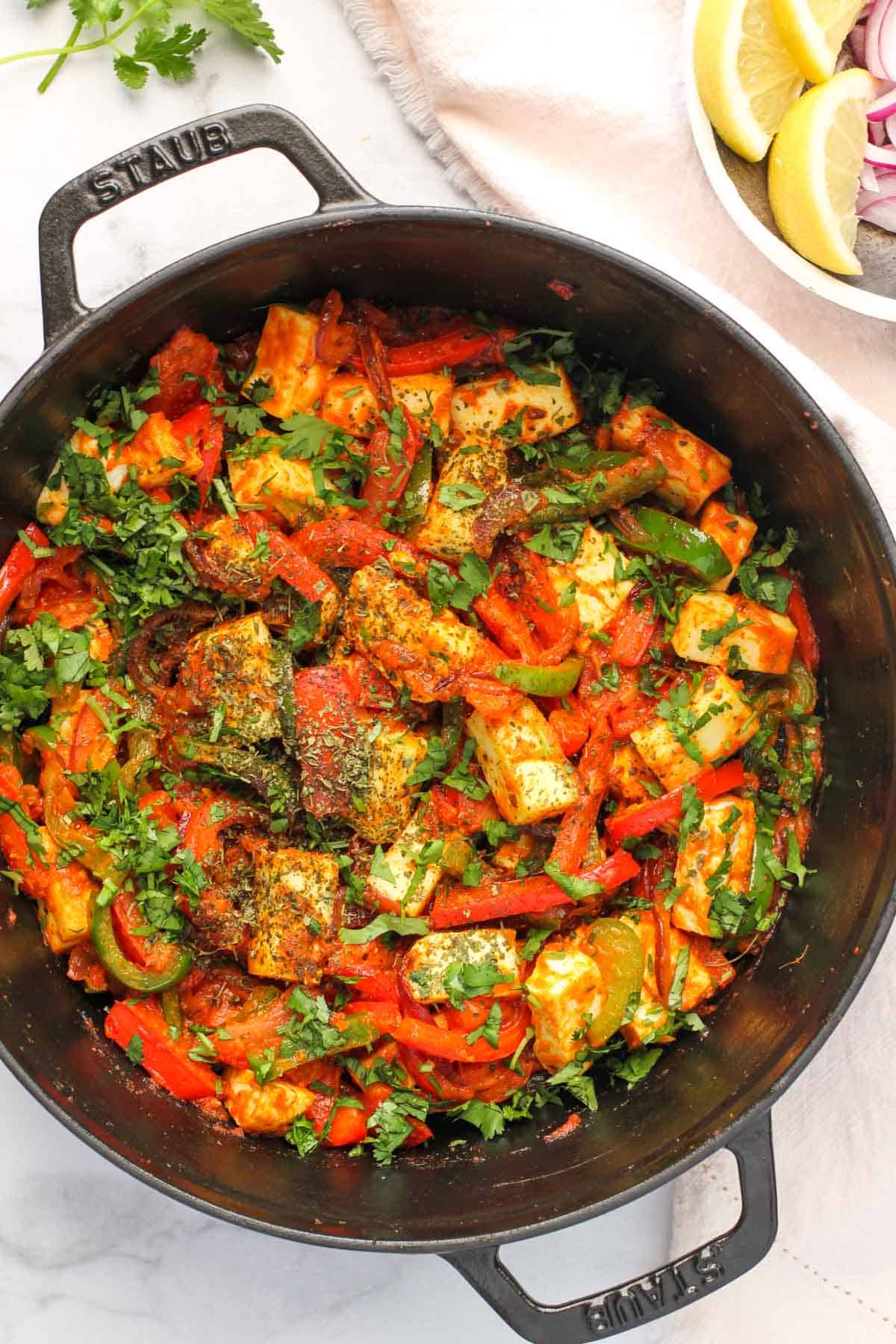 paneer and pepper stir fry in a cast iron pan 