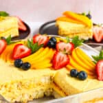 Mango Tiramisu in a glass dish topped with fresh fruit