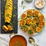Masawadi on a serving platter garnished with cilantro and served alongside rassa