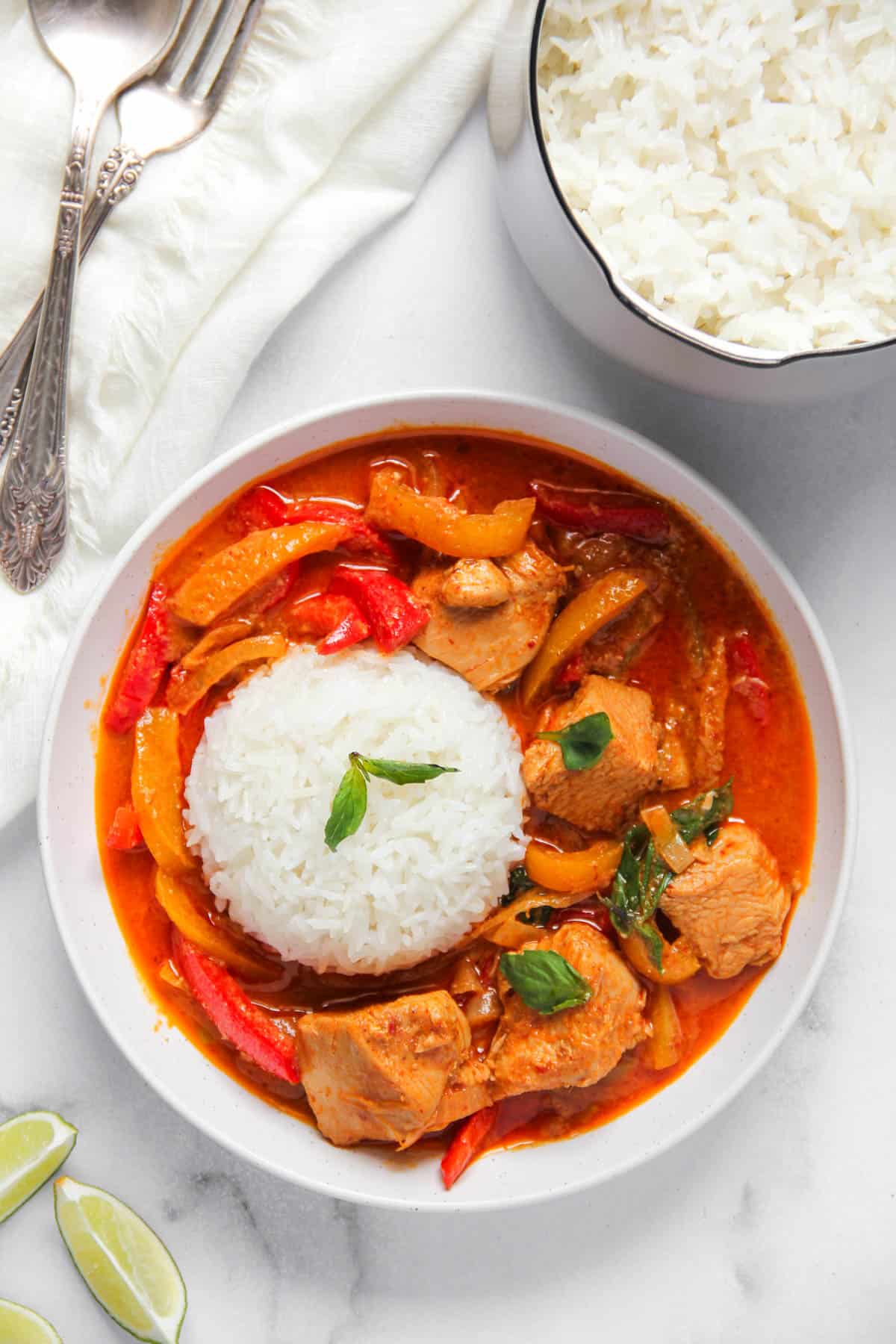 Thai panang curry served with jasmine rice in a white bowl