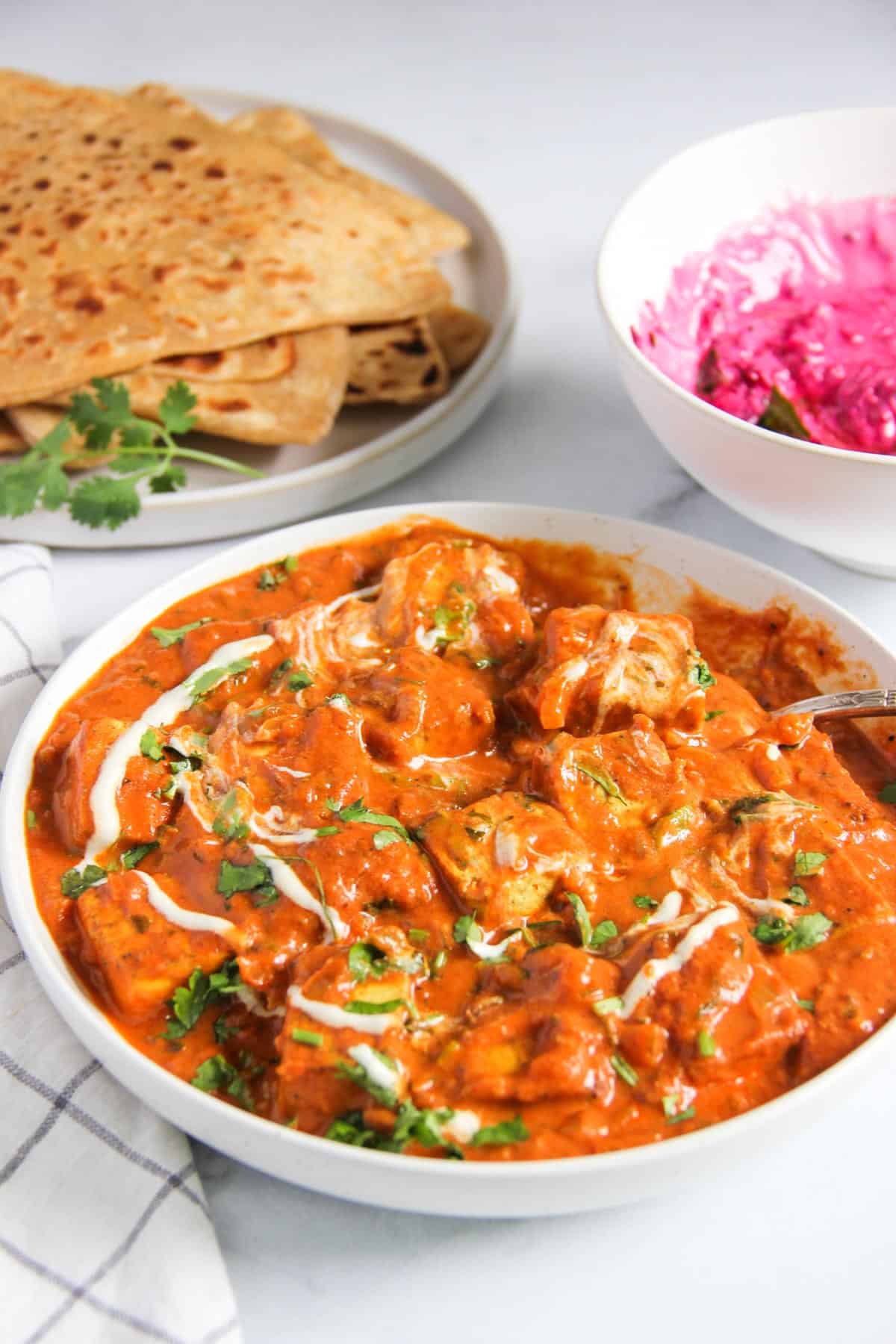 tofu makhani served with parathas and koshimbir