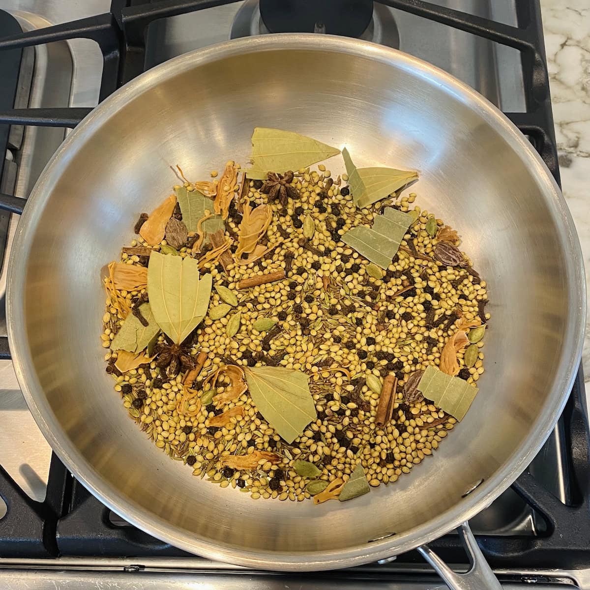 roasting whole spices in a pan 