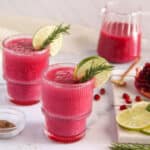 pomegranate spritzer garnished with roasemary and lime