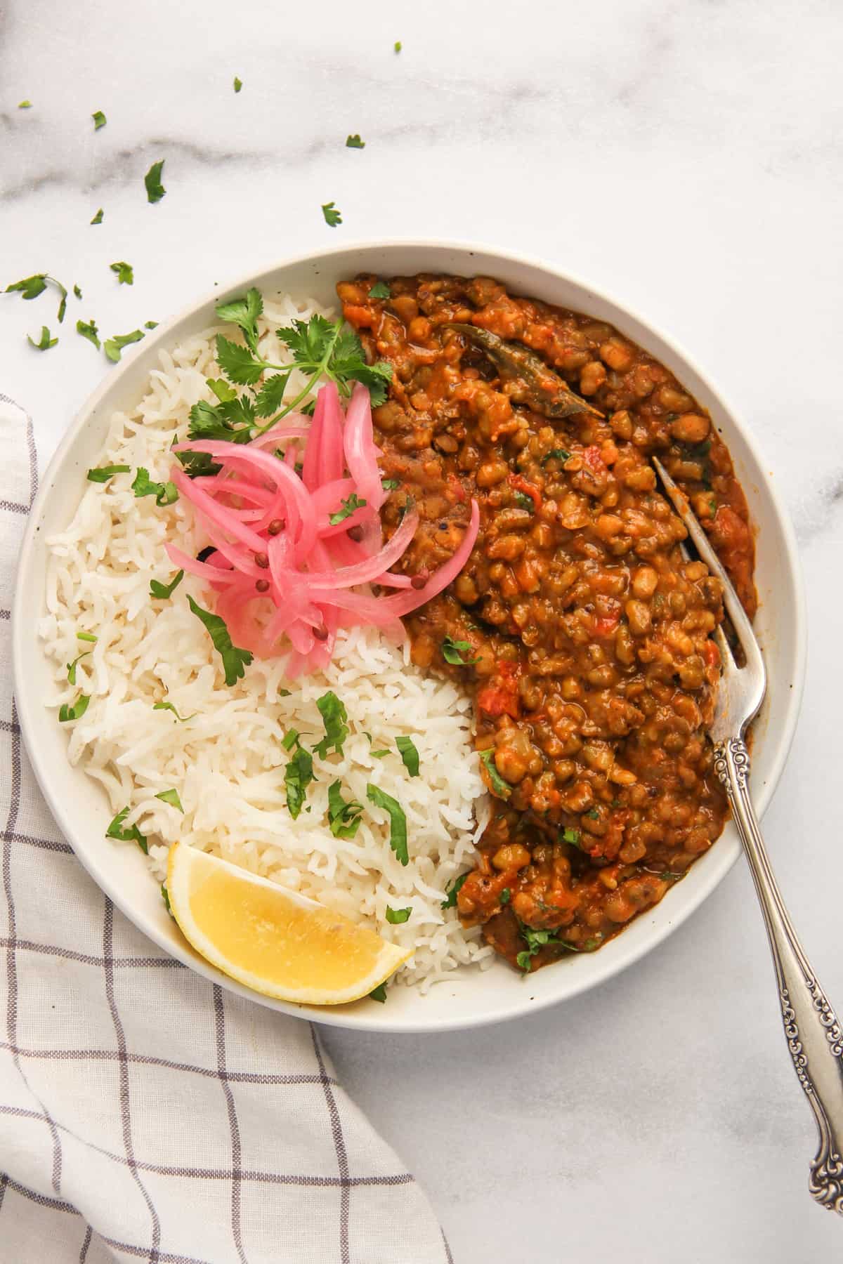 green moong dal served with rice and pickled onions