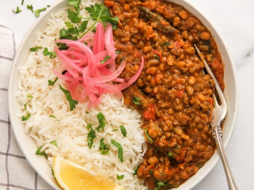 green mung dal served with rice and pickled onions