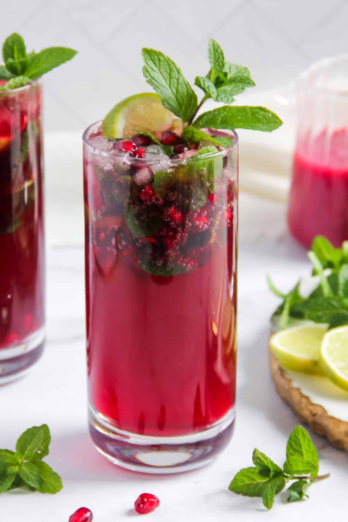 pomegranate mojito garnished with mint sprigs