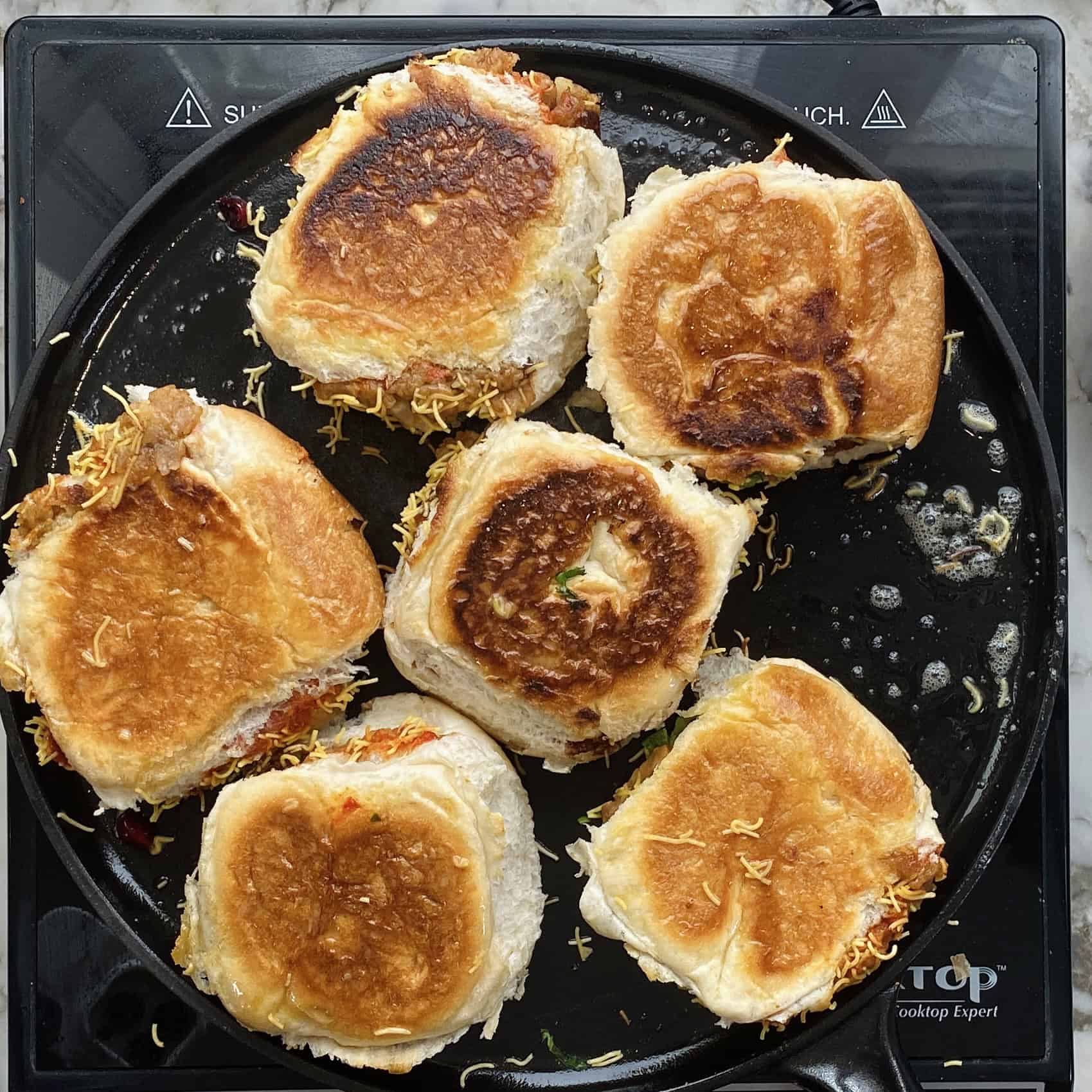 Toasty Dabeli on a pan.