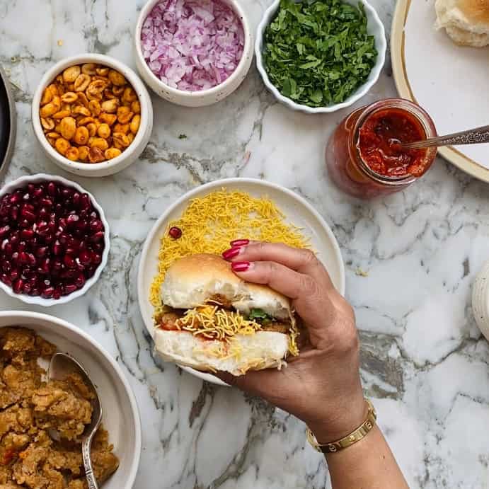 Dabeli dipped in sev.