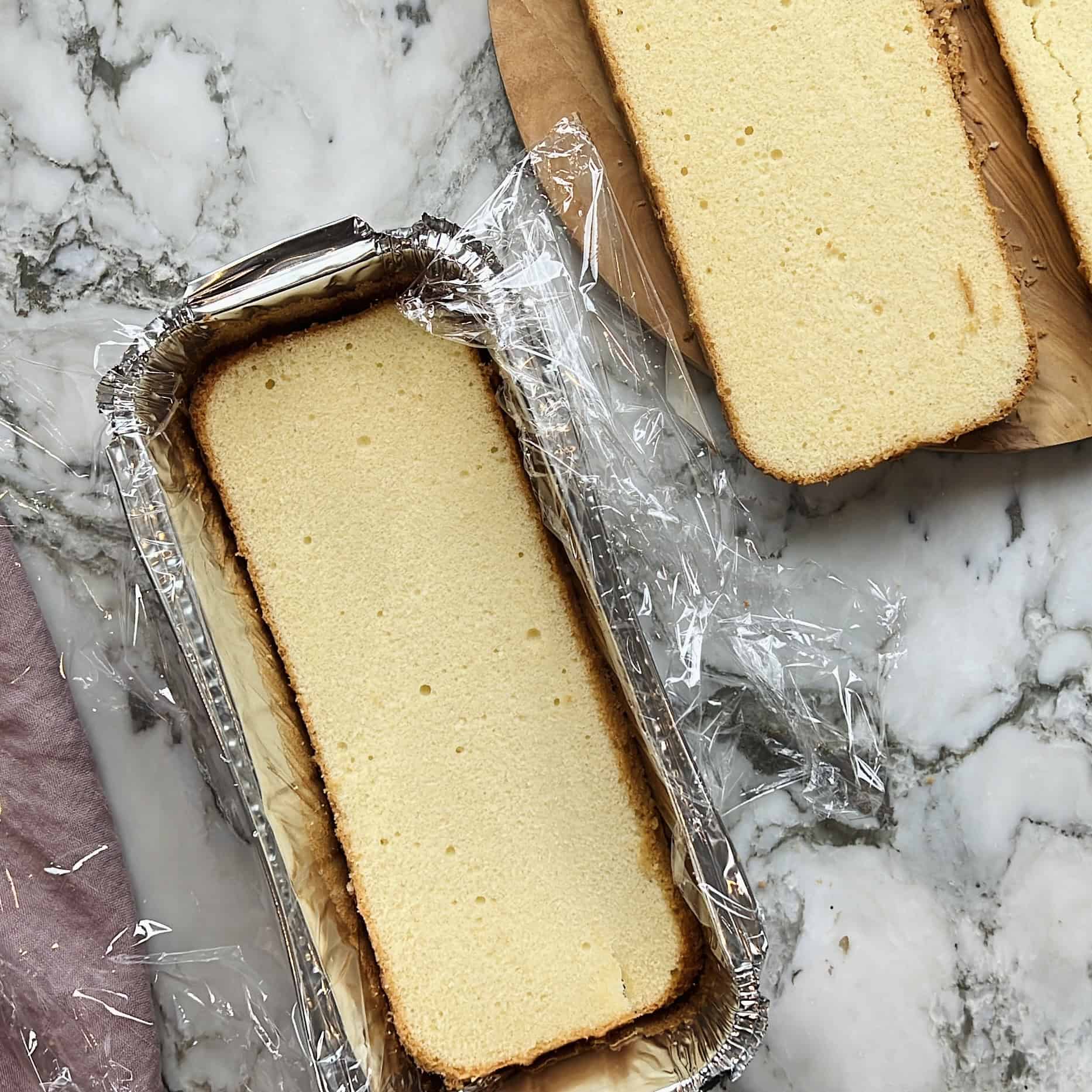 sliced pound cake in a aluminum loaf pan 