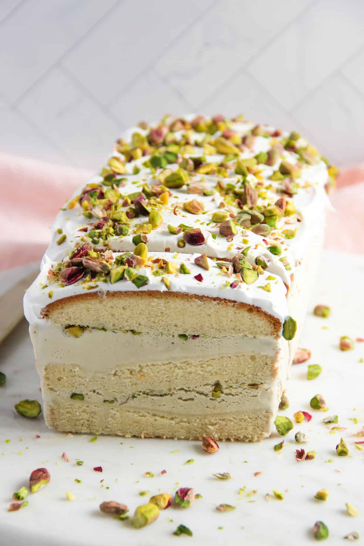 Pistachio Ice Cream Cake garnished with chopped pistachios. 