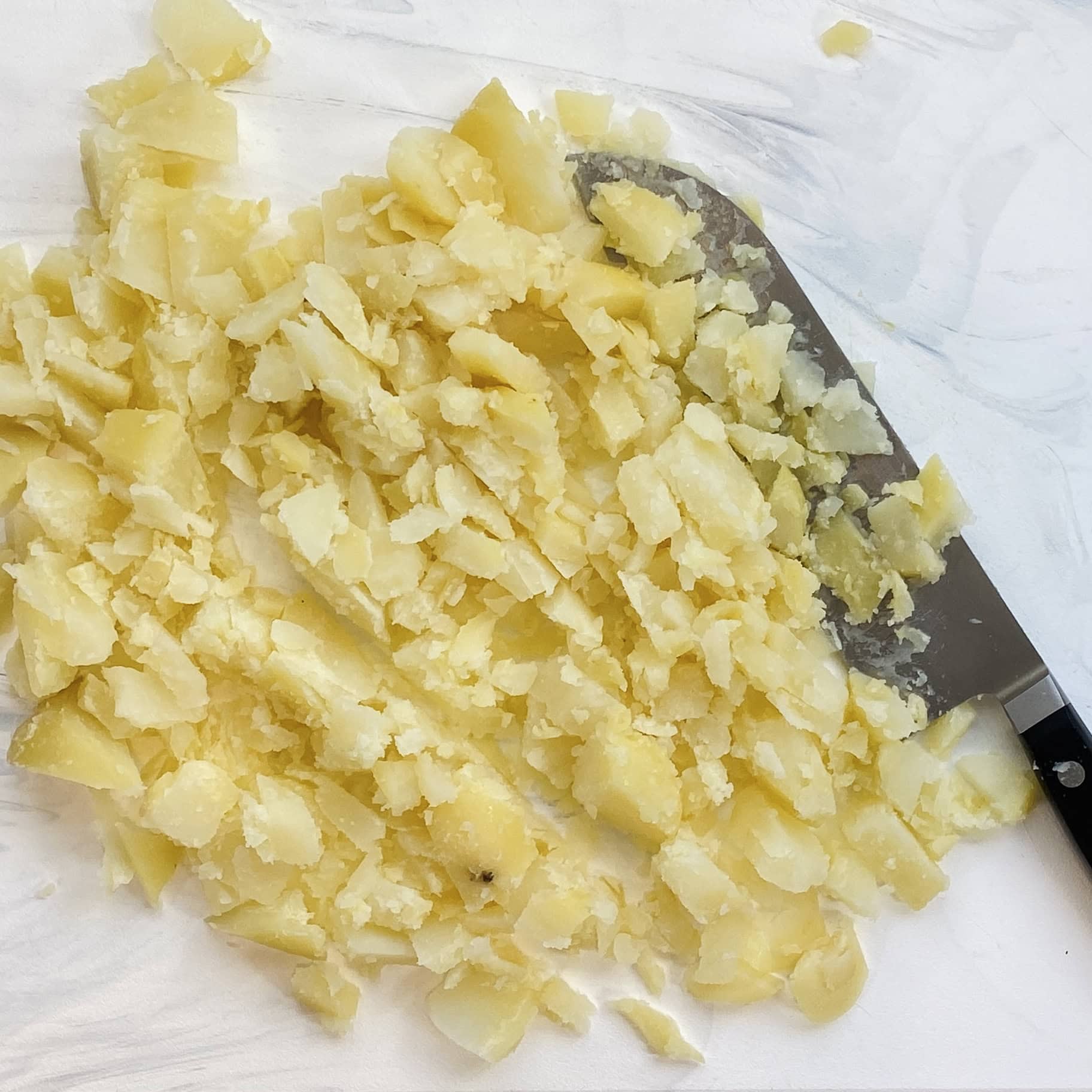 diced potatoes on a cutting board 