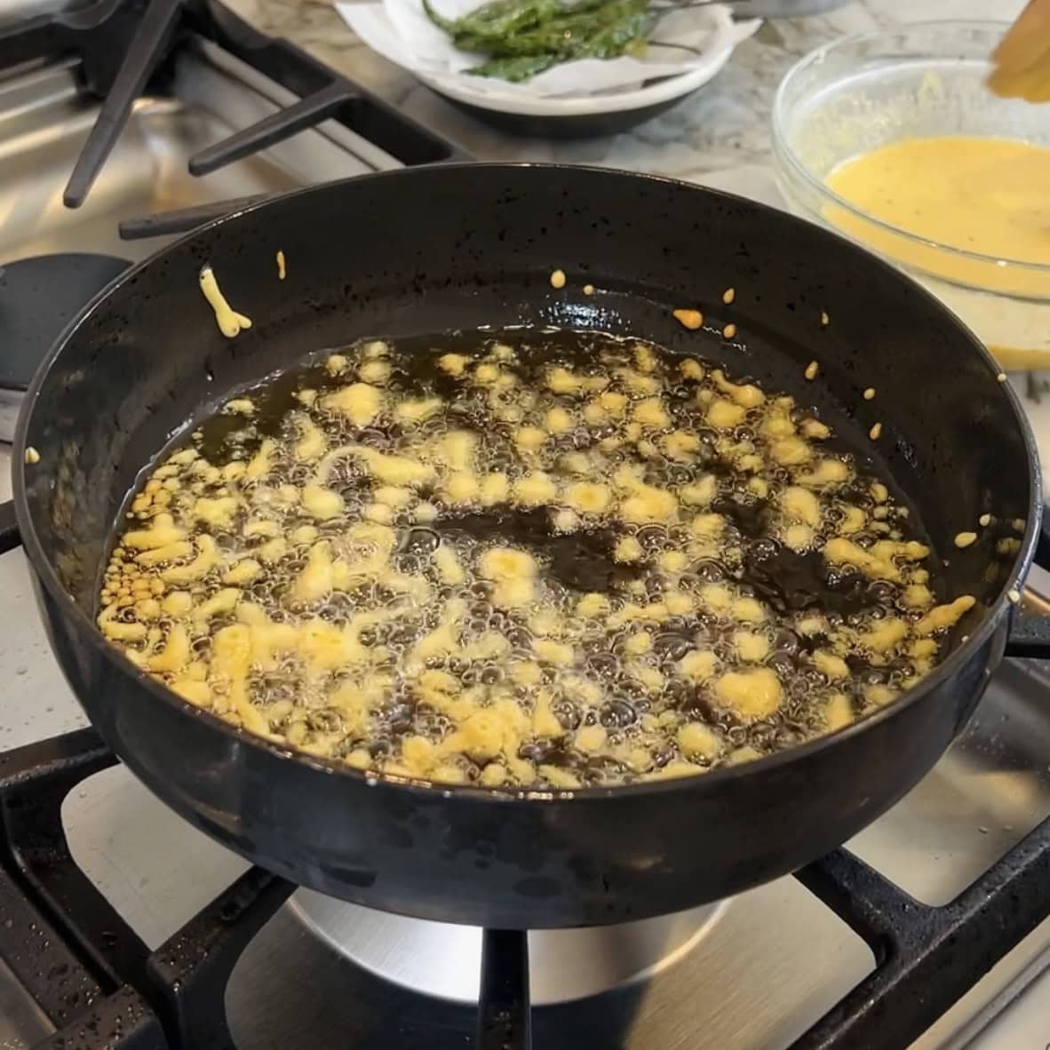 frying besan chura in a kadai 