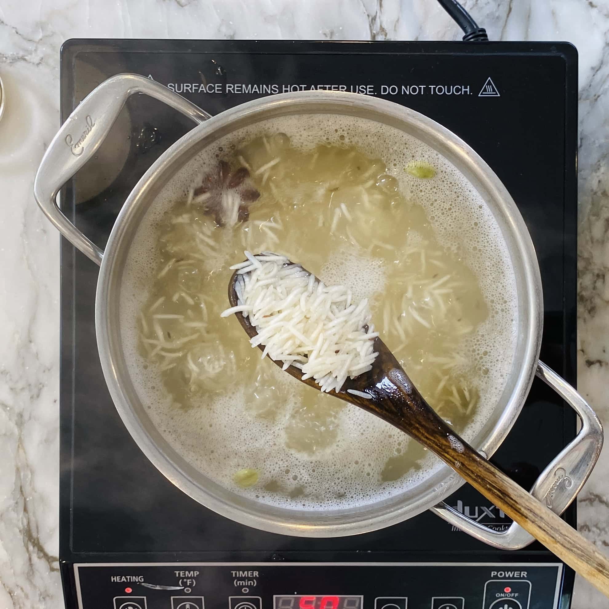 partially cooked rice in a pot 