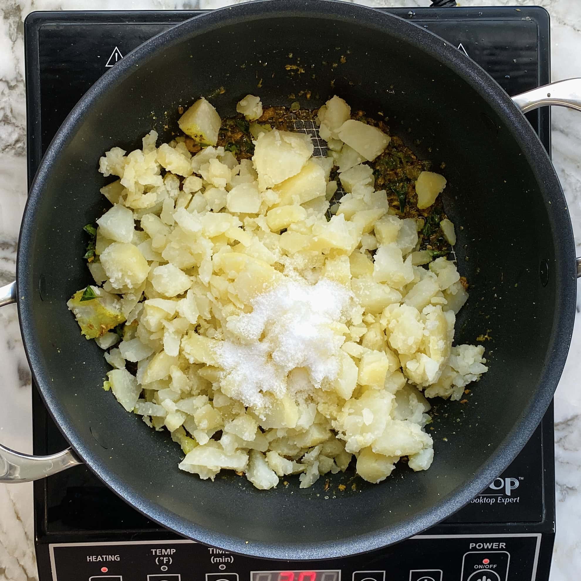 diced potatoes and salt in a non stick pan