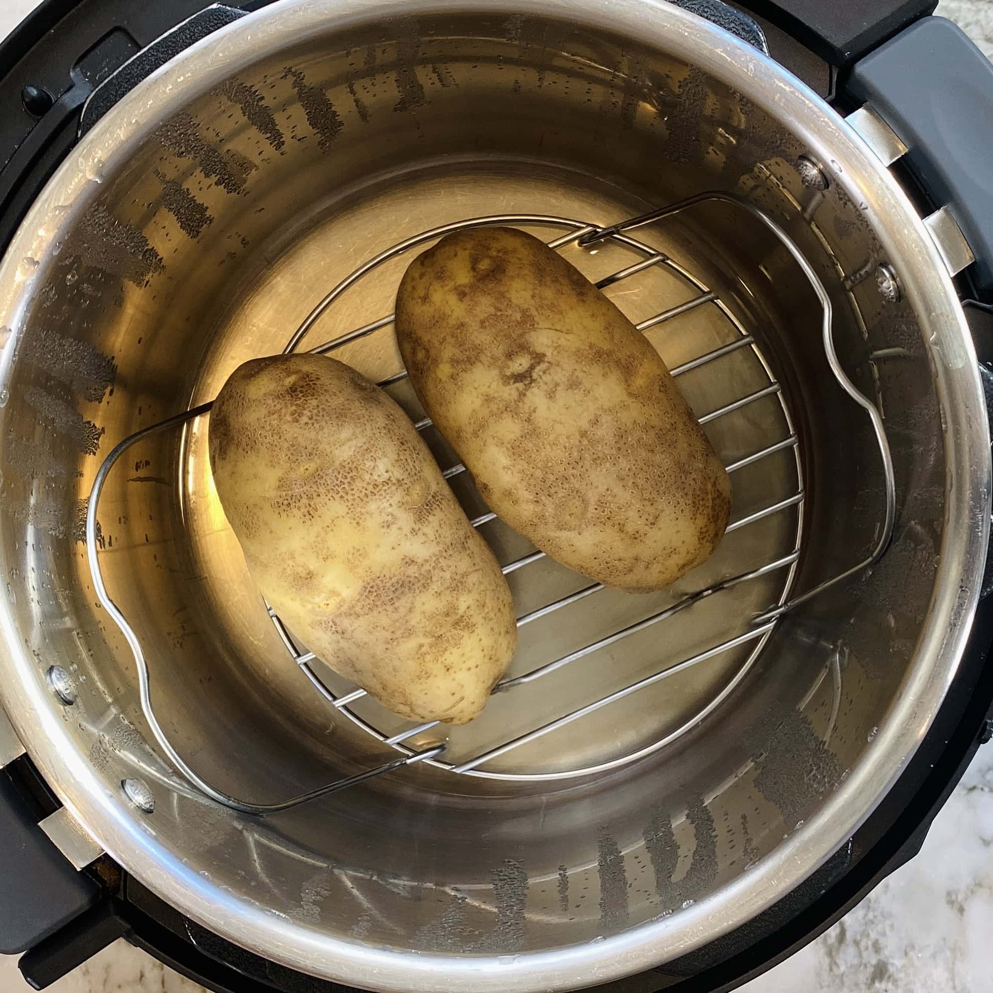 steamed potatoes inside Instant Pot trivet