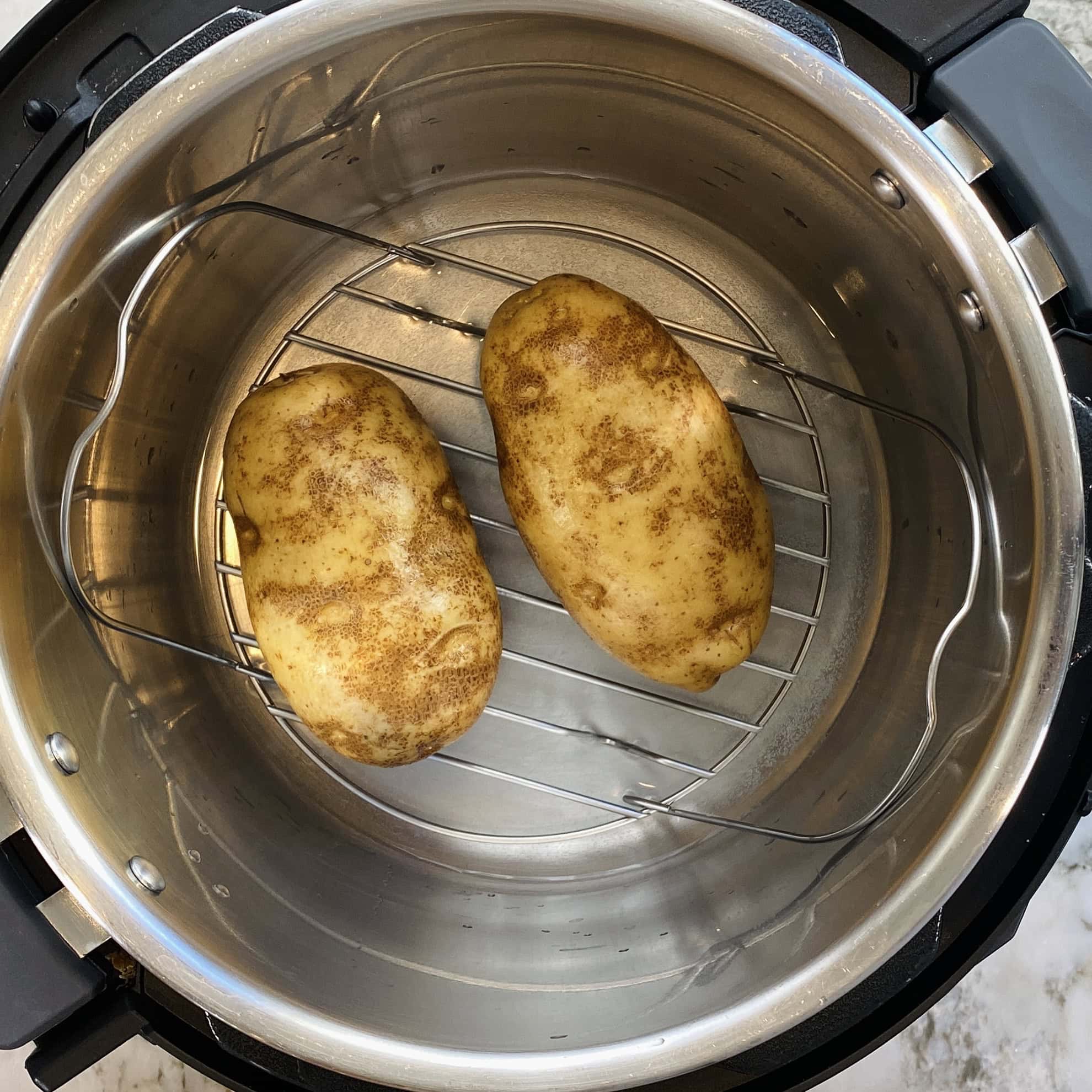 potatoes placed on a trivet inside the Instant Pot