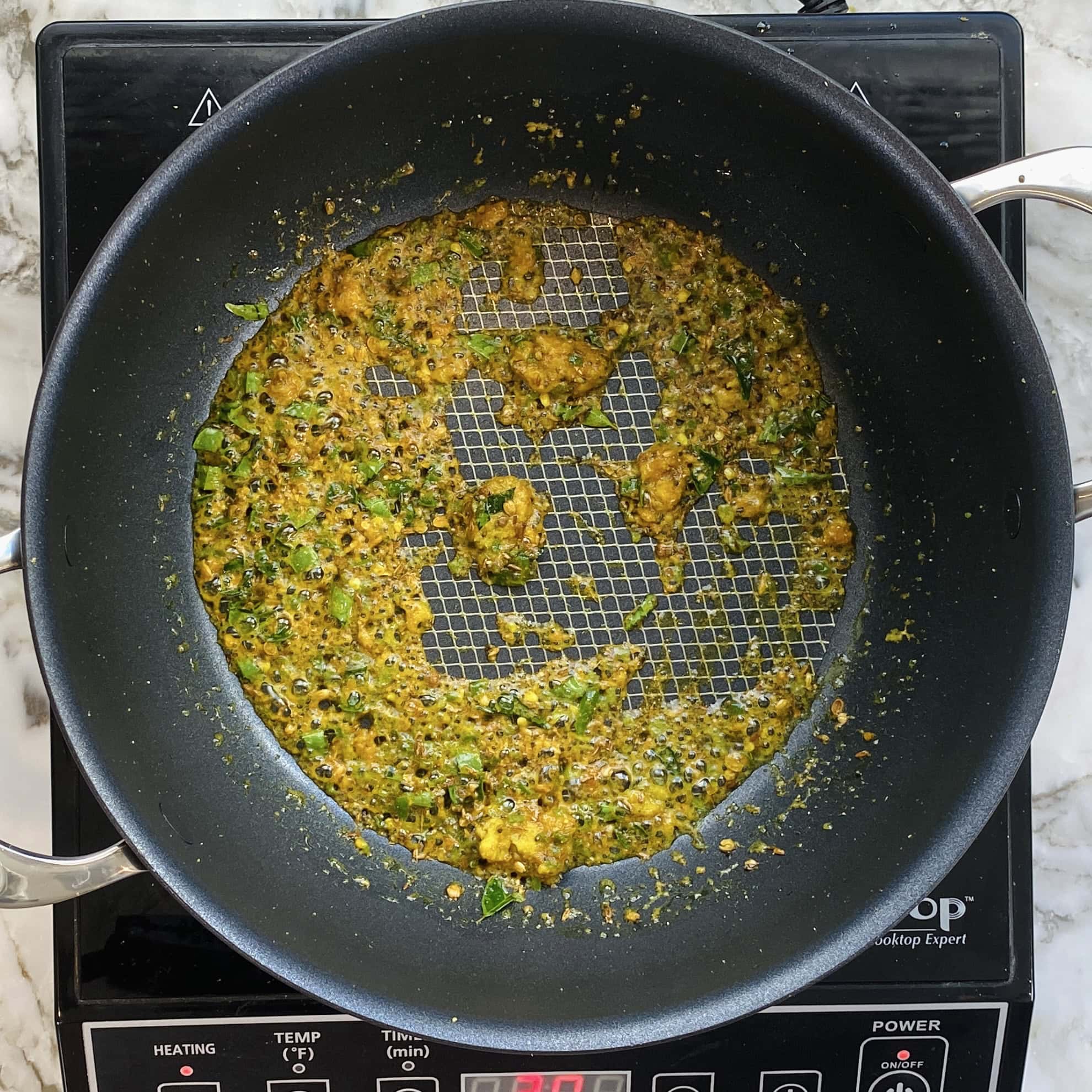 spice tadka in a non stick pan